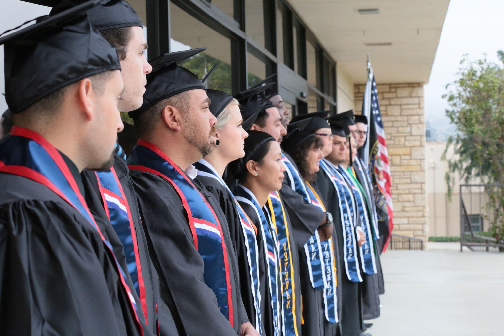 Students posing for a photo outside the VRC at graduation